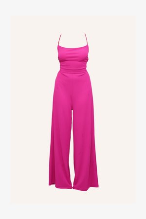 Fuchsia jumpsuit with thin straps, ribbed texture, fitted bodice, and wide-legged design. Smooth fabric with a fluid drape.