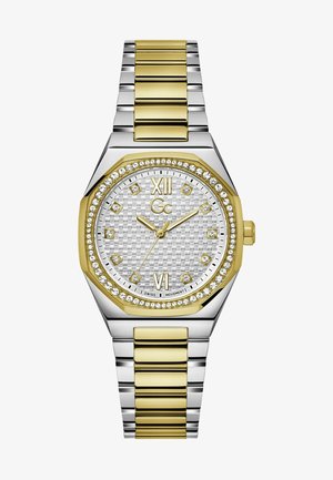 Silber- und goldfarbene Zweifarbenuhr mit achteckigem Gehäuse, strukturiertem silbernen Zifferblatt, Kristallakzenten und goldenen Stundenmarkierungen, ausgestattet mit einem Gliederarmband.