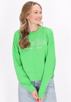 Zielony, krótki sweatshirt z bawełny, z okrągłym dekoltem i długimi rękawami. Na przodzie w biały napis "Widoczna Szczęśliwość".