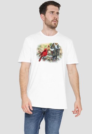 White cotton T-shirt featuring a colorful cardinal and birdhouse design in a winter scene. Short sleeves and a relaxed fit.
