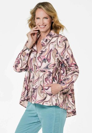 Leichte Jacke mit Blumenmuster in sanften Rosa-, Creme- und Lilatönen. Verfügt über lange Ärmel, einen Kragen und Seitentaschen.