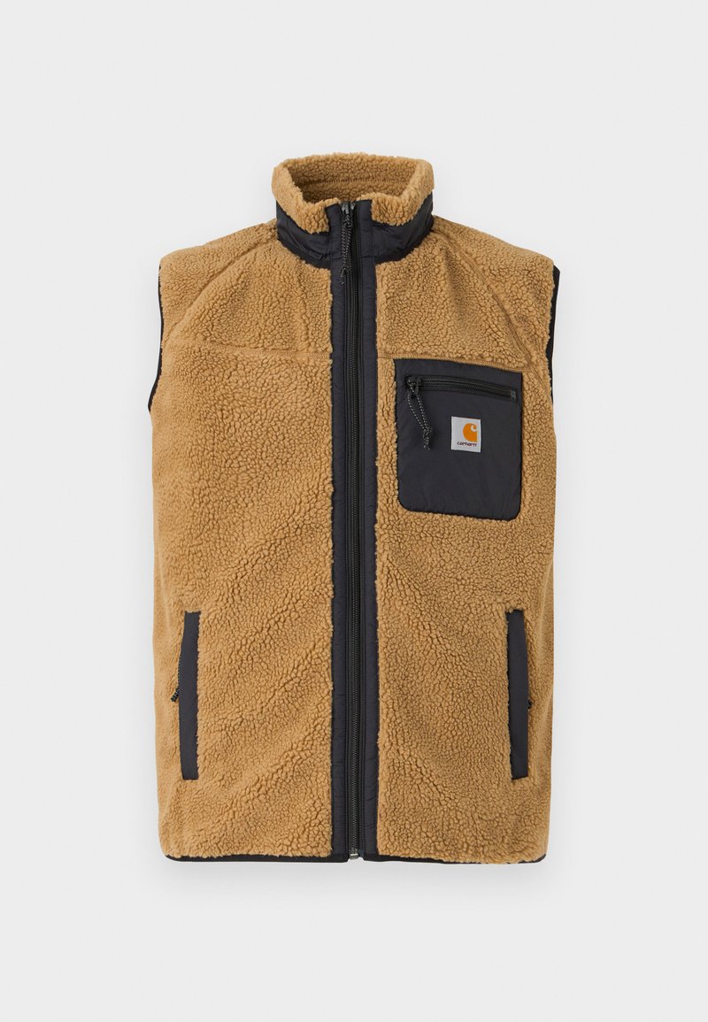 Fleece vest in tan met een hoge kraag, ritssluiting aan de voorkant en zwarte accenten. Beschikt over een klein borstzakje en zijzakken. Textuur op het oppervlak.
