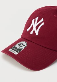 Μπορντό καπέλο μπέιζμπολ, από βαμβακερό υλικό, με λευκό λογότυπο και ραφές. Ρυθμιζόμενος ιμάντας στο πίσω μέρος, ετικέτα στην ρέλι με την ένδειξη "#47 CLEAN UP."