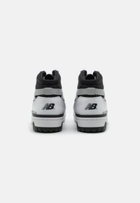 Wysokie sneakersy wykonane ze skóry w kolorze czarnym i szarym, z teksturowanym wzorem, wyściełanym kołnierzem oraz kontrastującą gumową podeszwą z logo.