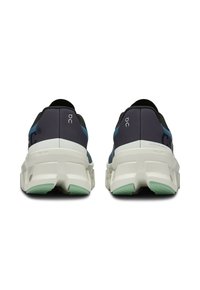 Black and navy running shoes with light green accents, featuring a thick white sole and a mesh upper for breathability and support.