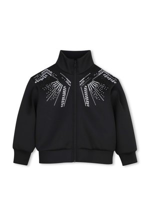Veste noire zippée avec col montant et motifs géométriques blancs en points sur la poitrine et les épaules.