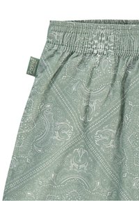 Svijetlozeljena tkanina s paisley uzorkom; elastična pojasnica; meka tekstura; oznaka vidljiva sa strane.