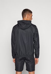 Sergio Tacchini PRANNIE TRACK JACKET - Chaqueta de entrenamiento - black/griffin