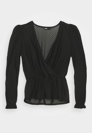 Blouse noire transparente à manches longues avec pois texturés, col en V profond à devant enveloppant, taille élastique et poignets froncés.