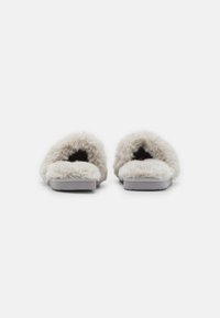 Faux fur slippers in light gray with a thick, fluffy exterior and a flat, textured rubber sole, featuring an open-toe design.