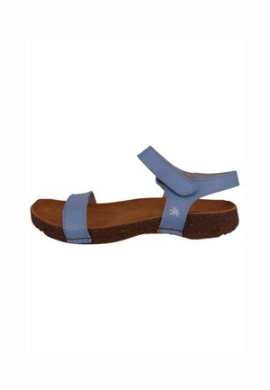 Blue leather sandal with two adjustable straps, cork midsole, and a flat sole. Features a small embroidered design on the strap.