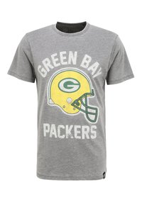 Harmaa puuvillapaita, jossa on keltainen jalkapallokypärä, jossa on vihreä logo ja teksti "GREEN BAY PACKERS" paksuilla valkoisilla kirjaimilla.