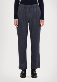 Pantaloni a gamba larga in misto lana, di colore blu scuro, con cintura elastica. Presentano un motivo a spina di pesce e un design frontale piatto.