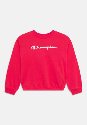 Rød sweatshirt lavet af blødt bomuld med lange ærmer, ribbede manchetter og rund hals. Har hvidt "Champion"-logo på forsiden.