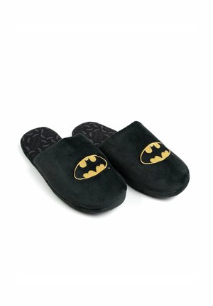 Black fabric slippers with gold Batman logo, soft texture, rounded toe, and patterned black interior featuring the Batman emblem.