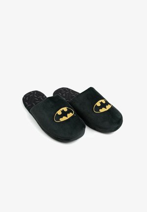 Black fabric slippers with gold Batman logo, soft texture, rounded toe, and patterned black interior featuring the Batman emblem.