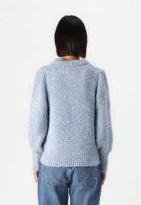 Light blue, fluffy knit sweater with a round neck, puffed sleeves, and ribbed hem. Soft texture with subtle shimmer throughout.