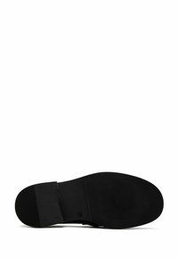Black shoe sole with a smooth texture, featuring a slightly raised heel and ribbed pattern for traction. Simple and functional design.