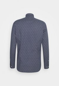 Chemise bleu marine à manches longues avec petit motif floral blanc, vue de dos, avec poignets boutonnés et col montant.
