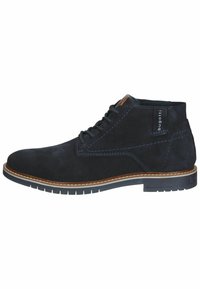 Botines de ante azul marino con ribete marrón en contraste y costuras blancas. Presentan una punta redondeada y cordones en la parte delantera.