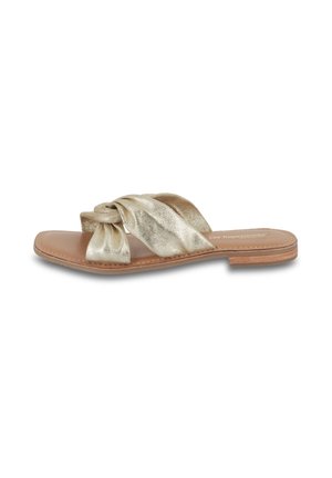 Gold metallic slide sandal with a knotted front strap, smooth leather sole, and exposed stitching. Open design, flat heel, minimalistic style.