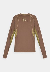 Long-sleeve brown shirt with olive green underarm panels and yellow stitching, featuring small stylized text and logo on chest center.