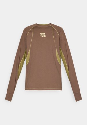 Long-sleeve brown shirt with olive green underarm panels and yellow stitching, featuring small stylized text and logo on chest center.