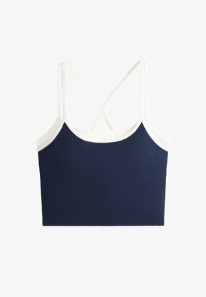 Top corto a coste blu navy con rifiniture bianche e sottili spalline bianche incrociate sul retro.