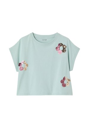 Light blue short-sleeve crop top with round neck, featuring three flower-shaped sequined patches in pink, gold, and brown tones.