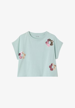 Light blue short-sleeve crop top with round neck, featuring three flower-shaped sequined patches in pink, gold, and brown tones.