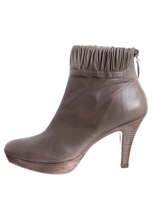 Brown leather ankle boot with a gathered top, high heel, and platform sole. Features a side zipper and textured heel. Smooth finish.