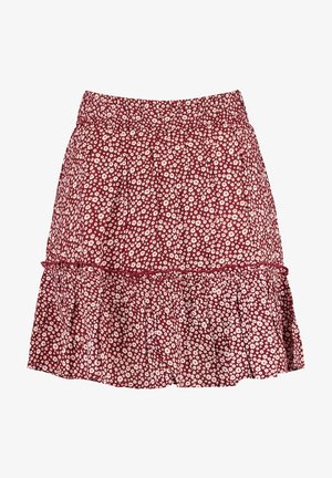 Jupe rouge avec un petit imprimé de marguerites blanches, taille élastique et détail de ourlet froncé.