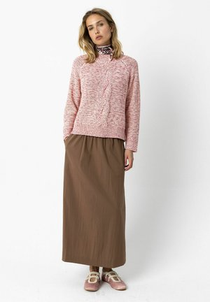 Pink and white speckled knit sweater with a textured pattern, paired with a long brown skirt and light pink shoes with straps.