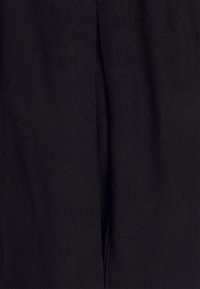 Black fabric featuring a smooth texture with slight sheen. The material is woven, displaying soft draping and subtle variations in surface.