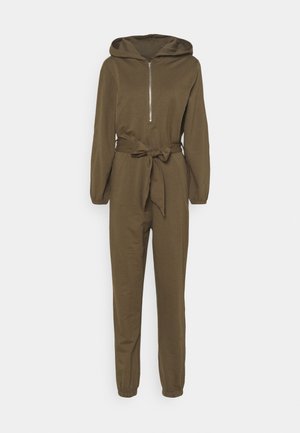 Brown hooded jumpsuit with long sleeves, front zipper, elastic cuffs, and a tied fabric belt at the waist.