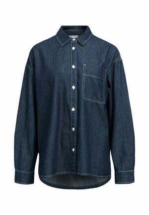 Traper košulja tamnoplave boje, s prednjim zatvaranjem na kopčanje, šiljastim ovratnikom, dugim rukavima i džepom na prsima. Suptilni bijeli šavovi su vidljivi.