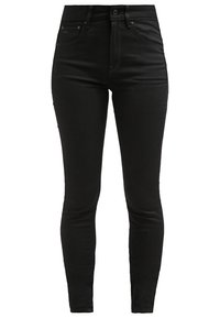 Jean skinny en denim noir avec taille haute, design à cinq poches, texture lisse et logo de marque discret près de la taille.