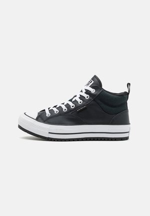High-top sneaker made of black leather with a white rubber sole, contrasting black and white stripes, and round toe. Features lace-up design.