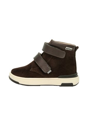 Chaussure montante en suède marron avec deux bretelles ajustables à velcro, semelle intermédiaire blanche et semelle extérieure noire. Présente des détails de couture et une étiquette de logo.