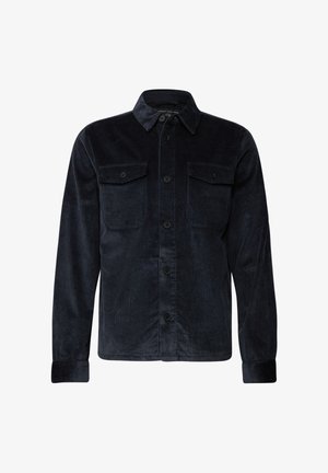 Camicia di velluto a coste blu navy con maniche lunghe, chiusura frontale a bottoni, due tasche sul petto e colletto classico. Presenta una texture a coste e bottoni neri.