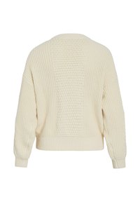 Pull en tricot crème à coupe décontractée, doté d'un panneau arrière texturé, de poignets et d'un ourlet côtelés. Tissu doux de poids moyen.