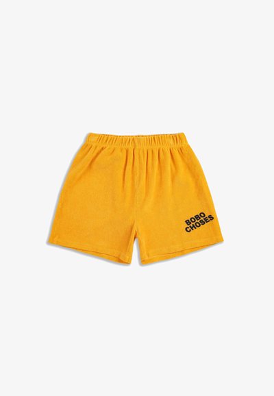 Yellow terry fabric shorts with an elastic waistband and the text "BOBO CHOSES" in black on the lower right side.