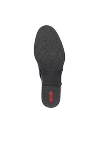 Black shoe sole with textured rubber surface; features grooved patterns and a red logo accent. Structured with a rounded heel design.
