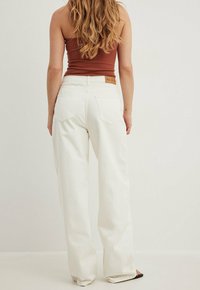NA-KD LANGE MIT MITTLERER TAILLE - Kavbojke na trapez - white