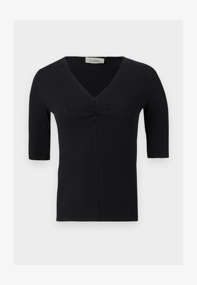 Haut noir à manches courtes avec col en V et détail froncé au centre devant, fabriqué en tissu côtelé, présenté sur un fond uni.