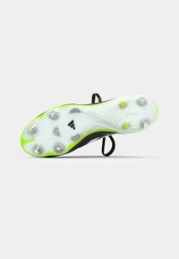 Black soccer cleat with a lightweight, white outsole. Features neon green accents, six metallic studs, and a textured surface for traction.