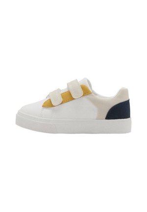White sneaker with two beige velcro straps, yellow side detail, and navy heel patch, flat rubber sole, viewed from outer side.