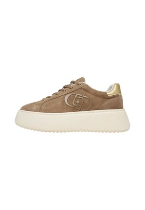 Bruine suède sneaker met dikke witte zool, veters aan de voorkant, gouden hielaccent en een gestileerd logo aan de zijkant.