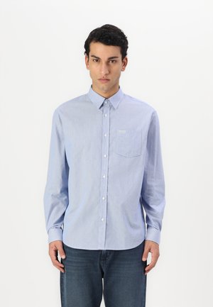 Light blue striped button-up shirt with a collar, long sleeves, and a chest pocket. Finished with white buttons and a logo tag.