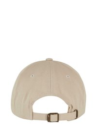 Cappello in cotone beige con cinturino metallico regolabile sul retro, dettagli cuciti e fori di ventilazione. Texture liscia, forma arrotondata.